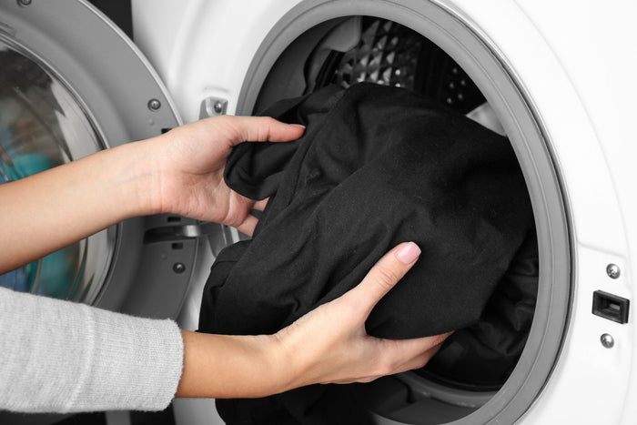 Hands removing clothes from washing machine